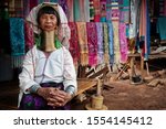 Chiang Rai Province, Thailand, Karen Long Neck woman wearing traditional brass rings in hill tribe village near Chiang Rai.