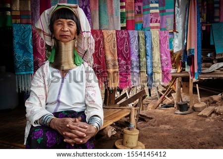 Chiang Rai Province, Thailand, Karen Long Neck woman wearing traditional brass rings in hill tribe village near Chiang Rai.