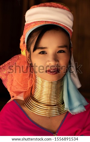 Chiang Rai Province, Thailand, portrait of young Karen Long Neck woman wearing traditional clothing and brass rings in hill tribe village near Chiang Rai.