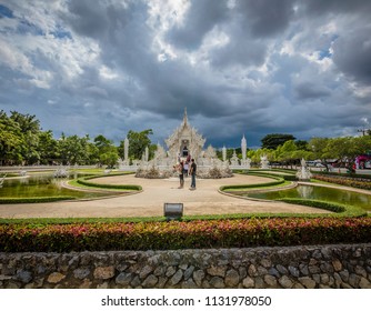 Chiang Rai (Thailand) - 10 June 2017: People Are Visiting The Wat Rong Khun, Better Known As The White Temple, A Contemporary And Unconventional Buddhist Temple In Chiang Rai Province 
