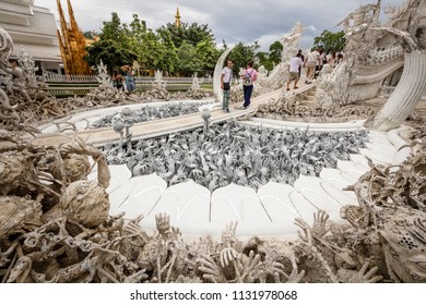 Chiang Rai (Thailand) - 10 June 2017: People Are Visiting The Wat Rong Khun, Better Known As The White Temple, A Contemporary And Unconventional Buddhist Temple In Chiang Rai Province 
