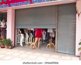 Chiang Rai, Thailand - 23 August 2014 : A Clothing Store That Is Getting Ready To Open By Half-lifting Its Rolling Door