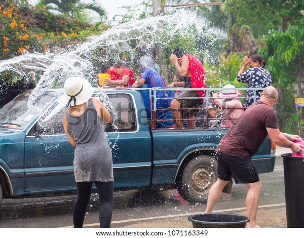 CHIANG RAI,\
Thailand - April 14, 2018: Tourists shooting water and having fun\
at Songkran festival, The Songkran festival or Thai New Year\'s\
festival, on Road in Chiang rai,\
Thailand.