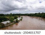 Chiang Rai, Thailand - August 17 2024: Mae Kok river level is getting higher due to heavy monsoon precipitations. View from Kham Maenam Kok Bridge, Chiang Rai bypass Road 131.