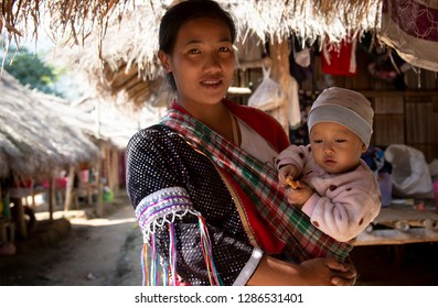 Chiang Rai (Thailand) - January 14th, 2019: Karen Hill Tribe Woman With Her Baby In The Huai La Development Karen Village