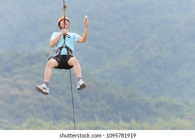 Chiang Rai, Thailand. November 24, 2017. Man Tourist Wearing Casual Clothing Is Playing Zip Line And Selfie At Singha Park Chiang Rai. Thailand