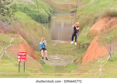 Chiang Rai, Thailand. November 24, 2017. Two Women Tourists Wearing Casual Clothing Are Playing Zip Line And Selfie At Singha Park Chiang Rai. Thailand