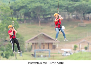 Chiang Rai, Thailand. November 24, 2017. Two Women Tourists Wearing Casual Clothing Are Playing Zip Line And Selfie At Singha Park Chiang Rai. Thailand