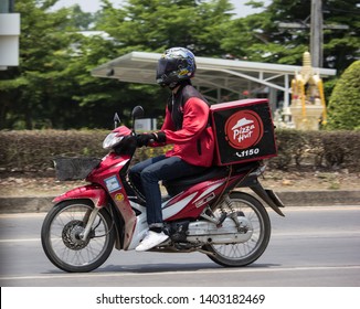 Chiangmai, Thailand - April 30 2019: Delivery service man ride a Motercycle of Pizza Hut Company. On road no.1001, 8 km from Chiangmai city.