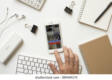 CHIANGMAI, THAILAND - FEBRUARY 16, 2016: Man Hand Touching On Apple IPhone 6s Button And Open Pinterest IOS App On Office Desk. Pinterest Is Photo Sharing Website.