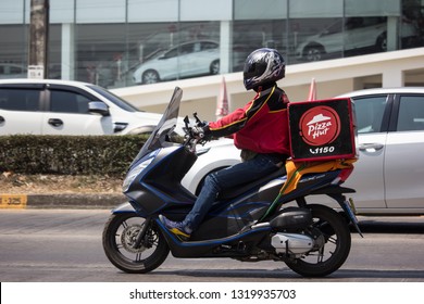 Chiangmai, Thailand - February 21 2019: Delivery service man ride a Motercycle of Pizza Hut Company. On road no.1001, 8 km from Chiangmai city.