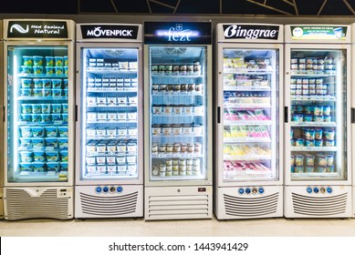 CHIANGMAI, THAILAND - JULY 4, 2019 - Different Brands And Flavors Of Ice Cream Stacked On Fridge Shelves In A Supermarket. Huge Glass Door Freezer Aisle With Variety Pack Of Ice Cream.