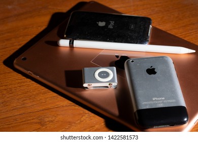 CHIANGMAI , THAILAND - JUN 13 2019: IPad And Apple Pencil With IPhone 2G, IPod Shuffle And IPod 2Gen On Wooden.