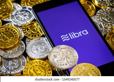 Chiangmai, Thailand - June 27th, 2019: Smartphone with Libra logo on the screen and Cryptocurrency digital golden coins, Facebook announces Libra cryptocurrency in easy to use concept