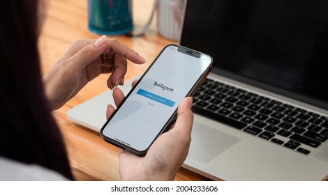 CHIANGMAI, THAILAND - MAY 3, 2021 : Woman holding iPhone 11 with Instagram app on screen at table, closeup - Shutterstock ID 2004233606