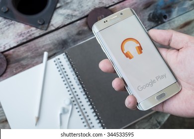 CHIANGMAI, THAILAND -NOV 28, 2015, A man hand holding screen shot of google play music . Google play music is the most interesting and a user friendly app to listen to music.