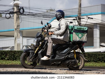 Chiangmai, Thailand - November 24 2021: Delivery service man ride a Motercycle of Grab Food. On road no.1001, 8 km from Chiangmai city.