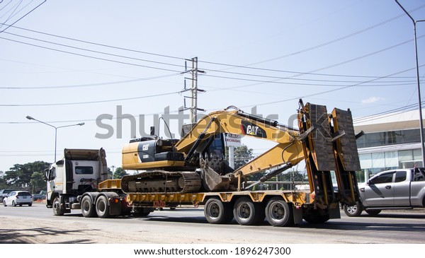 Chiangmai,\
Thailand -   November 27 2020:\
 Private  Cat Excavator on truck.\
On road no.1001, 8 km from Chiangmai\
city.