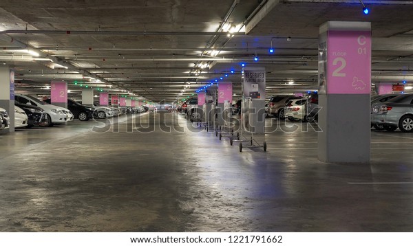Chiangmai, Thailland - NOVEMBER 5, 2018: Many parked\
cars in a parking garage of the central festival chiangmai shopping\
mall
