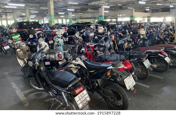 Chiangmai,THAILAND- February 3, 2021\
: Parking lot in the mall to protect from the hot sunlight and to\
protect the theft of cars and motorcycles, Safety in the parking\
lot.