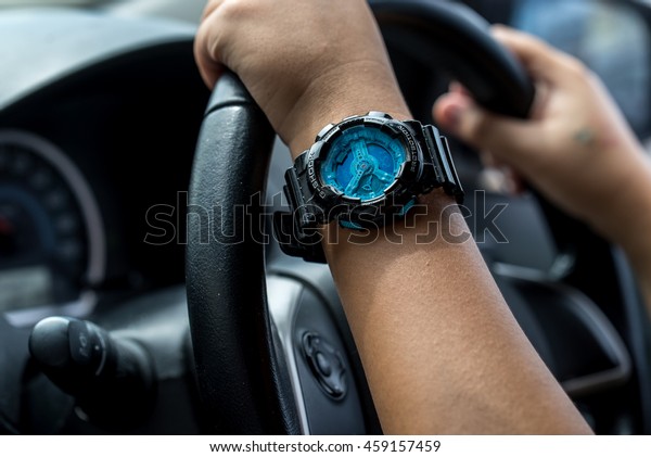 CHIANGMAI,THAILAND - JULY 27,\
2016:Asian female driving car with the Protrek watch with a triple\
sensor watch series of watches from the electronics manufacturer\
company\
Casio.