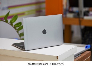 CHIANGMAI,THAILAND- MAY 17,2019: Close Up Back Side With Apple Mac Logo Of New Macbook Pro Core I5 Cpu Processor With Graphics Screen Of Monitor On White Table In Office At Chiangmai Thailand.