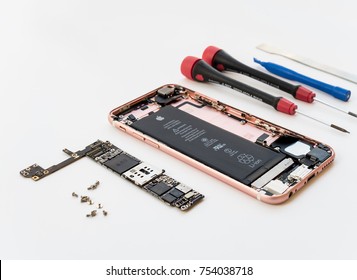 Chiangrai, Thailand: September 13, 2017 - Disassembled broken Apple iPhone 6s rose gold color preparing to repair or replace new part on white background.