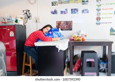 ChiangRai THAILAND-1:21:2018:The female employee in a laundromat is sleeping. in ChiangRai Thailand. - Shutterstock ID 1007392390