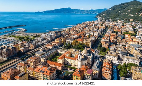 Chiavari, a charming coastal town in Italy's Liguria region, viewed from the air showcases its scenic waterfront, vibrant marina, and historic architecture nestled between the green hills - Powered by Shutterstock