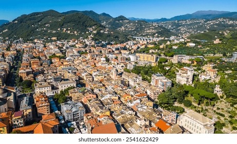 Chiavari, a charming coastal town in Italy's Liguria region, viewed from the air showcases its scenic waterfront, vibrant marina, and historic architecture nestled between the green hills - Powered by Shutterstock