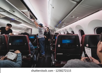 Chiba, Japan - April 16, 2017: Inside the cabin of Japan Airlines Boeing 787-900. Passenger are storing their luggage and belonging before the takeoff - Shutterstock ID 1258272115