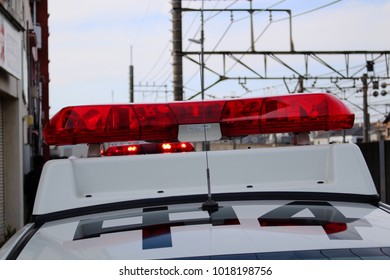 CHIBA, JAPAN - April 4, 2017: A Close-up Of Siren On The Roof Of A Japanese Police Patrol Car. Overhead Electric Lines Which Are Above Rail Tracks Are In The Background.