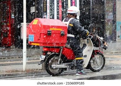 CHIBA, JAPAN - January 6, 2022: Post Office Mail Carrier On A Scooter On A Snowy Day.