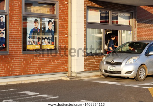  CHIBA, JAPAN - May 11, 2019: A car at the Part\
of a McDonalds restaurant with drive-thru section.It is located in\
Naruto in Sanmu City.  There are staff wanted posters in the\
store\'s windows.
