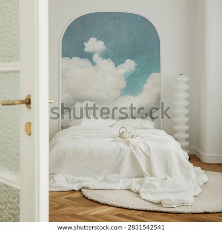 Chic bedroom interior featuring a cloud sky wall mural, white bed, and wooden floor. Peaceful, dreamy mood, ideal for home design and wellness concepts