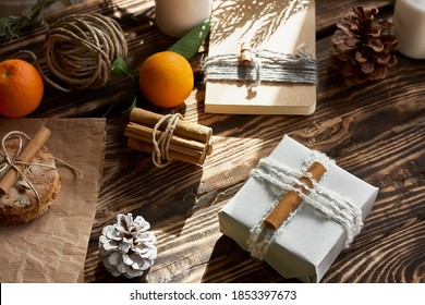 Chic cozy craft gift boxes on wooden background. Natural aestetic. Zero waste, plastic free, trendy hand made gift package for Christmas.