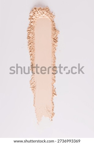 A chic example of the texture of a compact powder in a natural tone. texture of decorative cosmetics. copy space. A sample to advertise your product. vertical top view