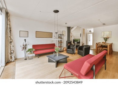 Chic living room with red sofas and black small square coffee table
