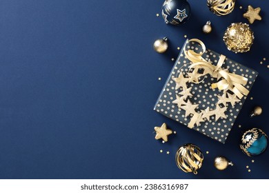 Chic navy Christmas gift box on a classic blue background with gold baubles. Elegant holiday card concept. Festive and stylish