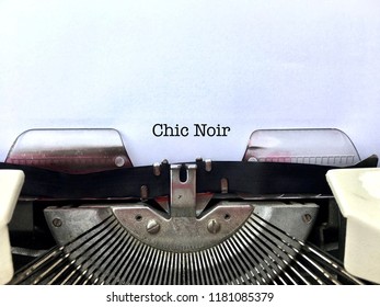 CHIC NOIR, Literature Genre Writing Style Heading Title Typewritten On Vintage Old Fashioned Manual Typewriter Machine On White Paper, Author Writing Style Concept Close Up