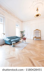 chic spacious light room in an old mansion in the classical style of the 19th century with a high ceiling decorated with stucco on white walls