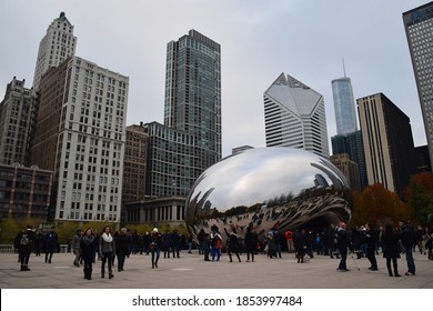 Chicaco, Illinois / USA - December 2 2016: People Looking At The Famous Tourist Attraction Cloud Gate (also Known As Chicago Bean) This Winter Day, With Skyscrapers In The Background