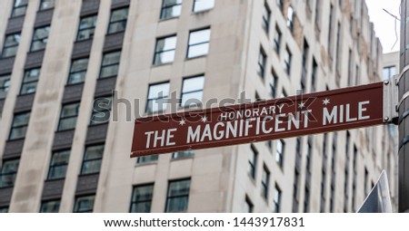 Chicago city downtown, The magnificent mile brown color street sign, City high rise buildings background, closeup view