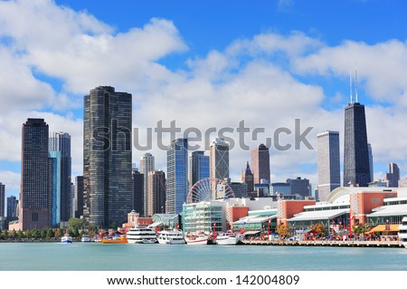 Chicago city downtown urban skyline with skyscrapers over Lake Michigan with cloudy blue sky.