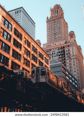 A Chicago cityscape featuring an elevated train passing through urban buildings. The scene captures the essence of city life with tall structures, bustling streets, and a dynamic urban atmosphere.

