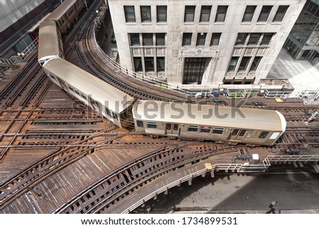 Chicago elevated train on its very old tracks rounding the corner in downtown Chicago during one of its many runs through the city.