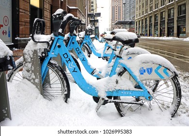 CHICAGO, IL -12 FEB 2018- Winter In Chicago. Snow Covers Divvy Bike Shares Blue Bixi Bicycles Parked On The Street In Downtown Chicago.
