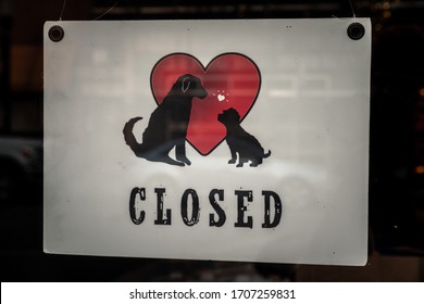 Chicago, IL - April 15th, 2020: A Closed Sign With Pet Graphics Is Posted On The Storefront Of A Small Business In Andersonville Neighborhood During The COVID-19 Pandemic And Stay At Home Orders.