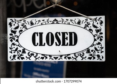 Chicago, IL - April 15th, 2020: A Decorative Floral Black And White Closed Sign Adorns A Storefront Window In A Small Business In Andersonville During The COVID-19 Pandemic And Stay At Home Orders.