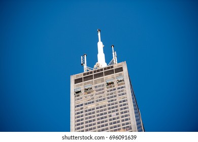 Chicago, IL, August 12, 2017: Top Of Willis Tower Downtown Chicago With A Distant View Of People Standing On The Clear Sky Deck, Which Protrudes Out Over The City Providing A Scary But Beautiful View